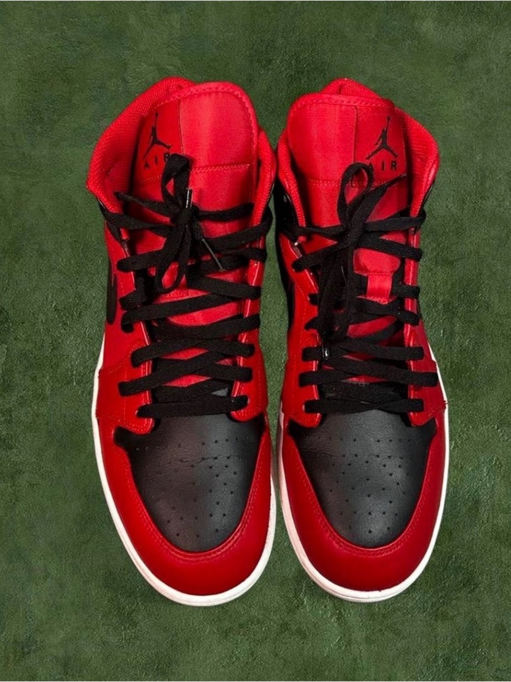 Nike Air Jordan 1 Mid sneakers in a gym red and black color way